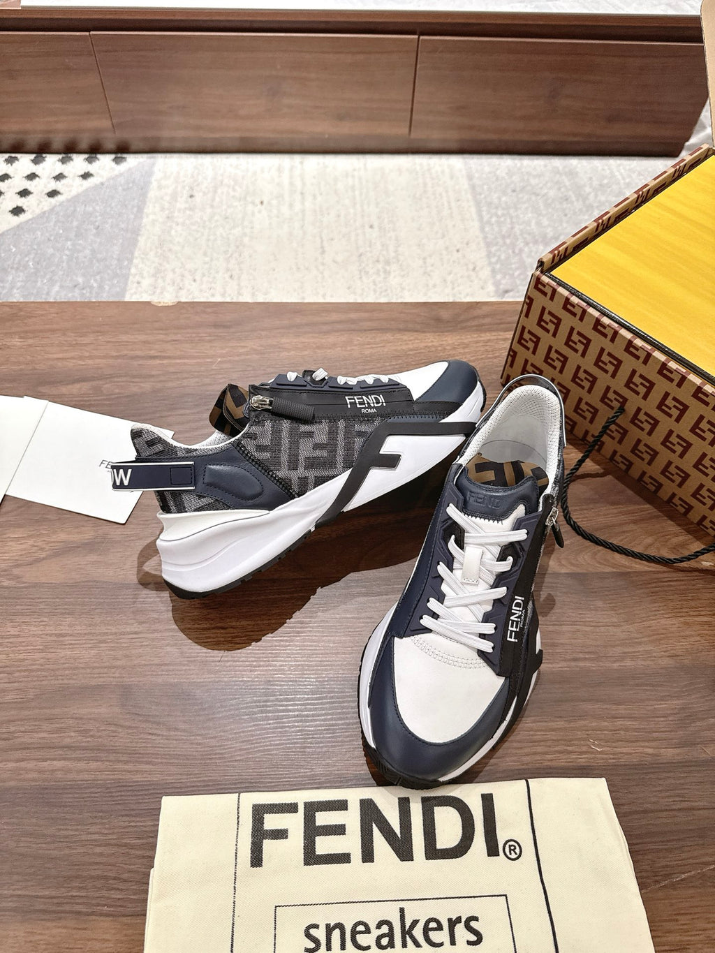 Navy and white FENDI sneakers with white laces, side stripe and logo tab