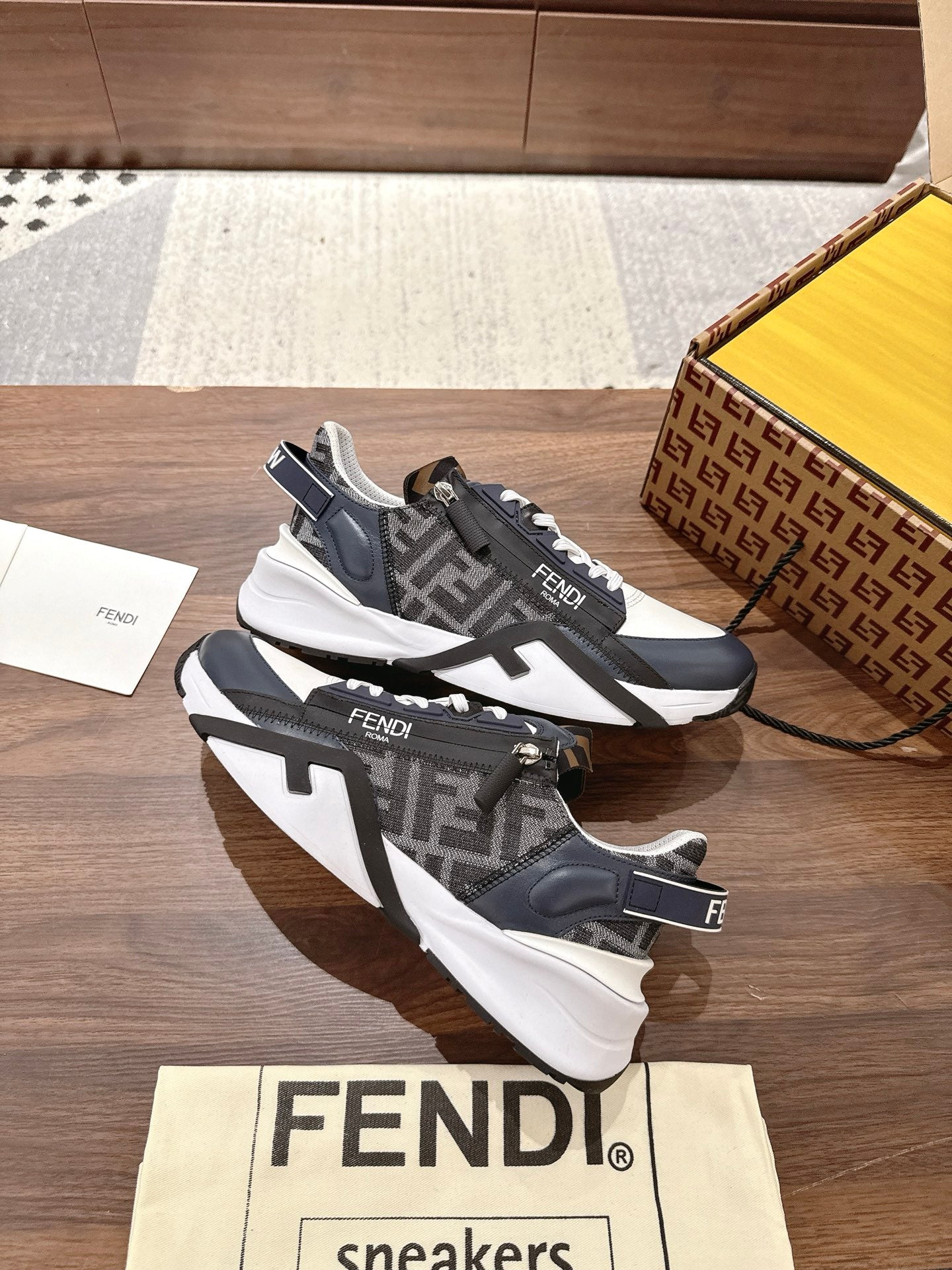 Dark and white FENDI sneakers with contrasting straps, laces and bold tread