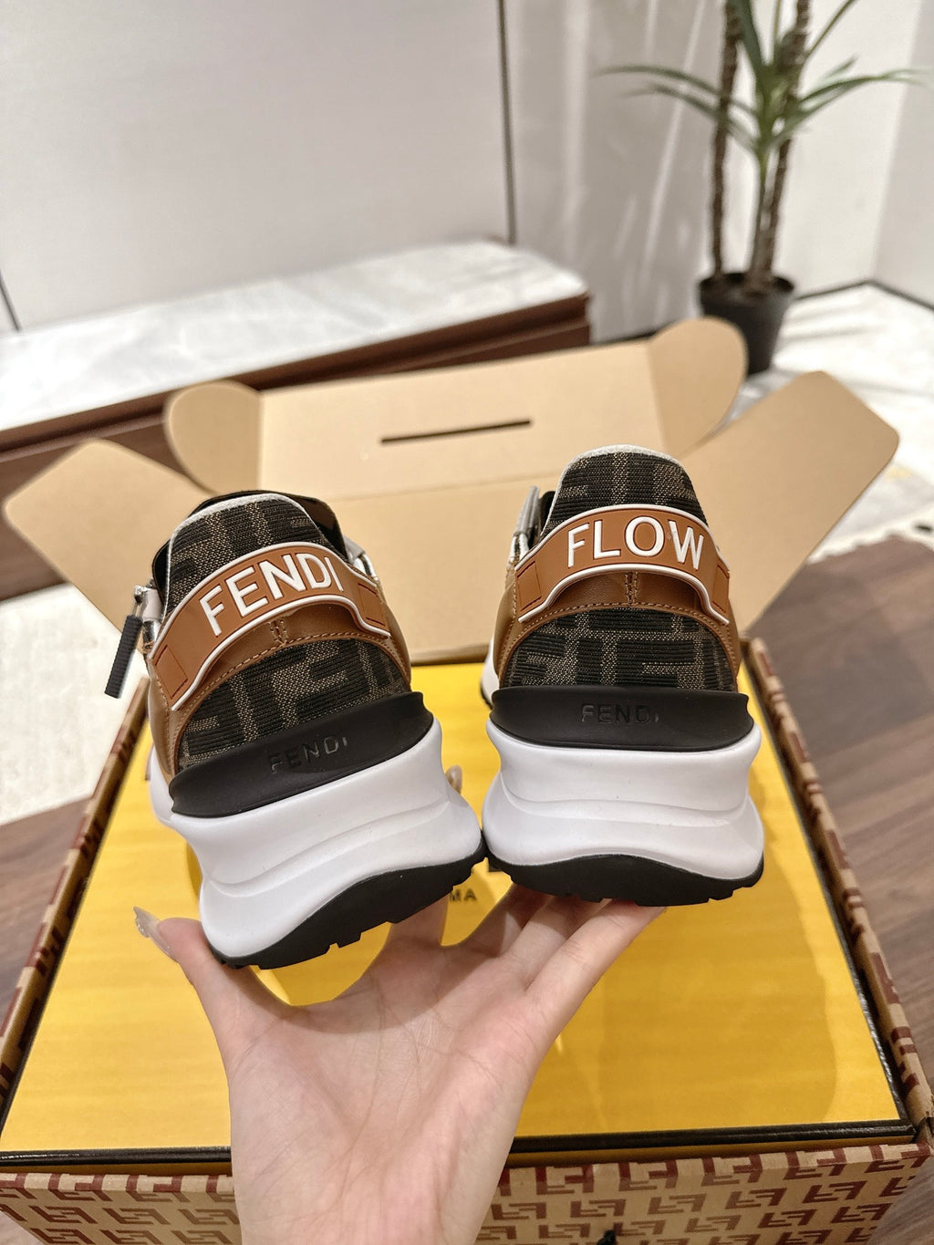 Fendi unisex sneakers heel view with brown and black uppers, white sole, and FLOW print