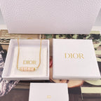 Gold-tone Dior letter necklace with pearl beads in a white presentation box