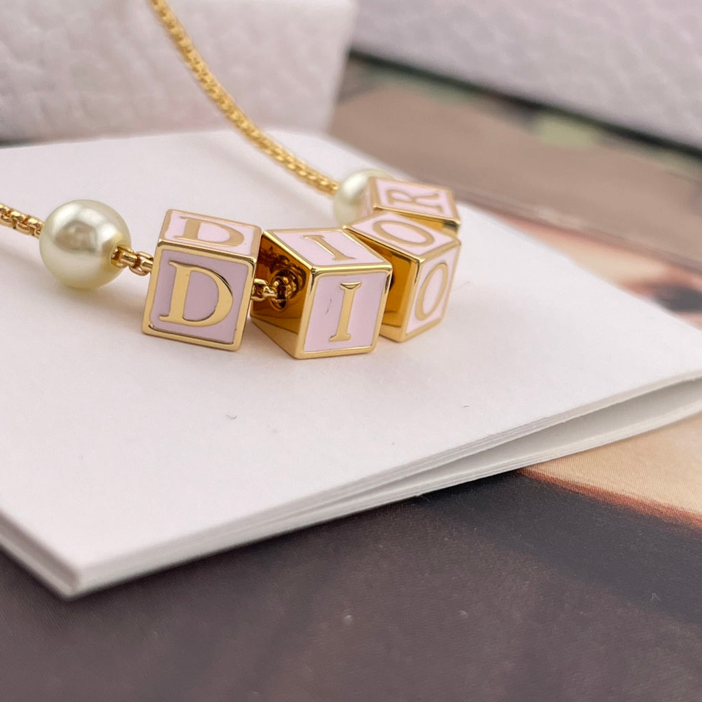 Gold-tone Dior letter charm necklace with two pearl beads and chain
