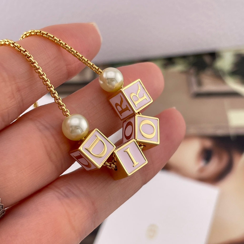 Gold-tone Dior letter and enamel cube charms with pearl bead on chain