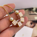 Gold-tone Dior letter and enamel cube charms with pearl bead on chain