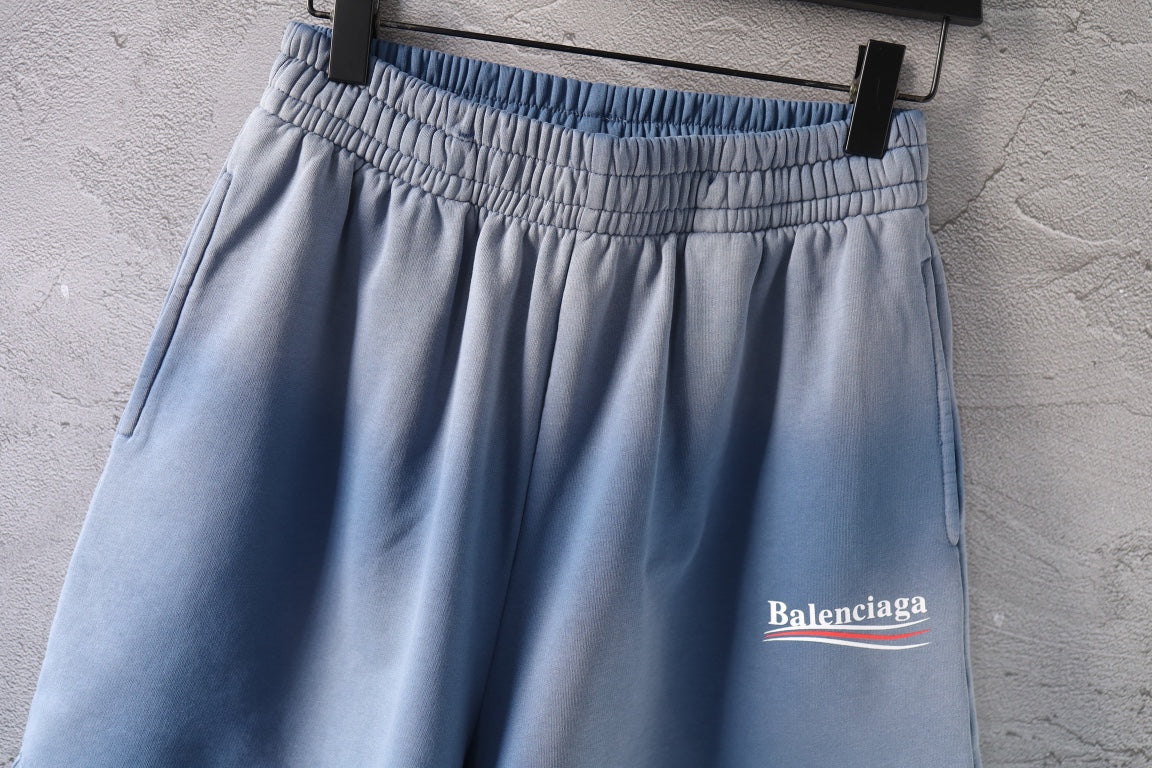Light blue denim shorts with elastic waistband and side logo patch