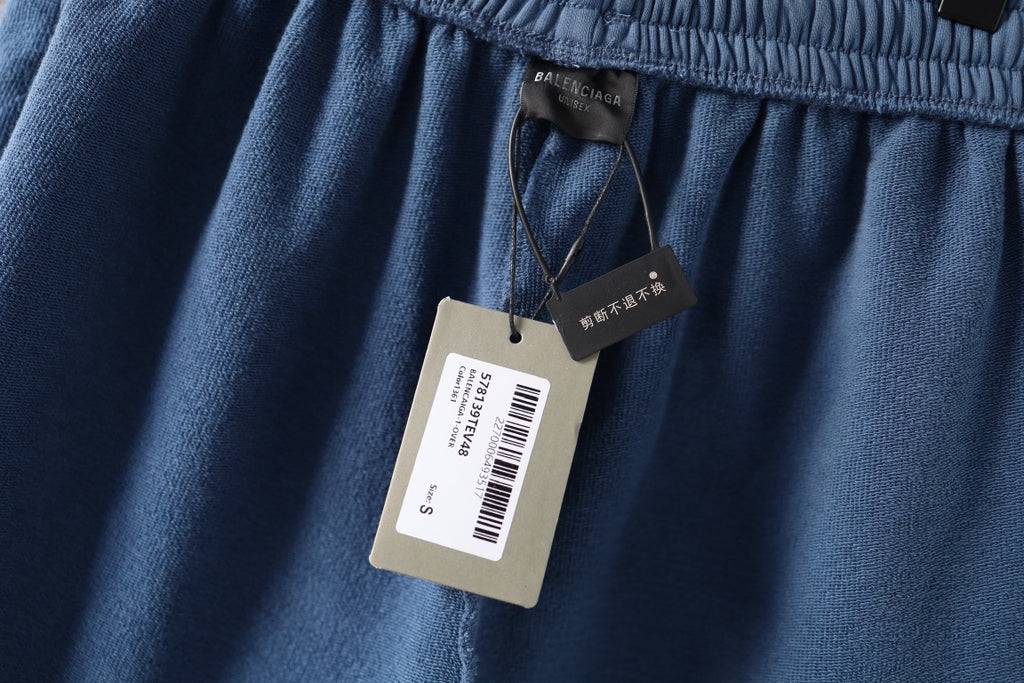 Light blue denim shorts with fabric tags hanging from waistband
