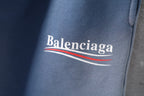 Light blue denim shorts with Balenciaga logo and striped underline detail