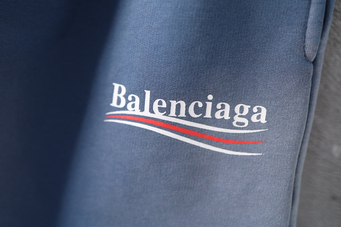 Light blue denim shorts with Balenciaga logo and striped underline detail