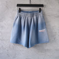 Light blue denim shorts with elastic waistband and side logo patch