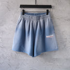 Light blue denim shorts with elastic waistband and side logo patch