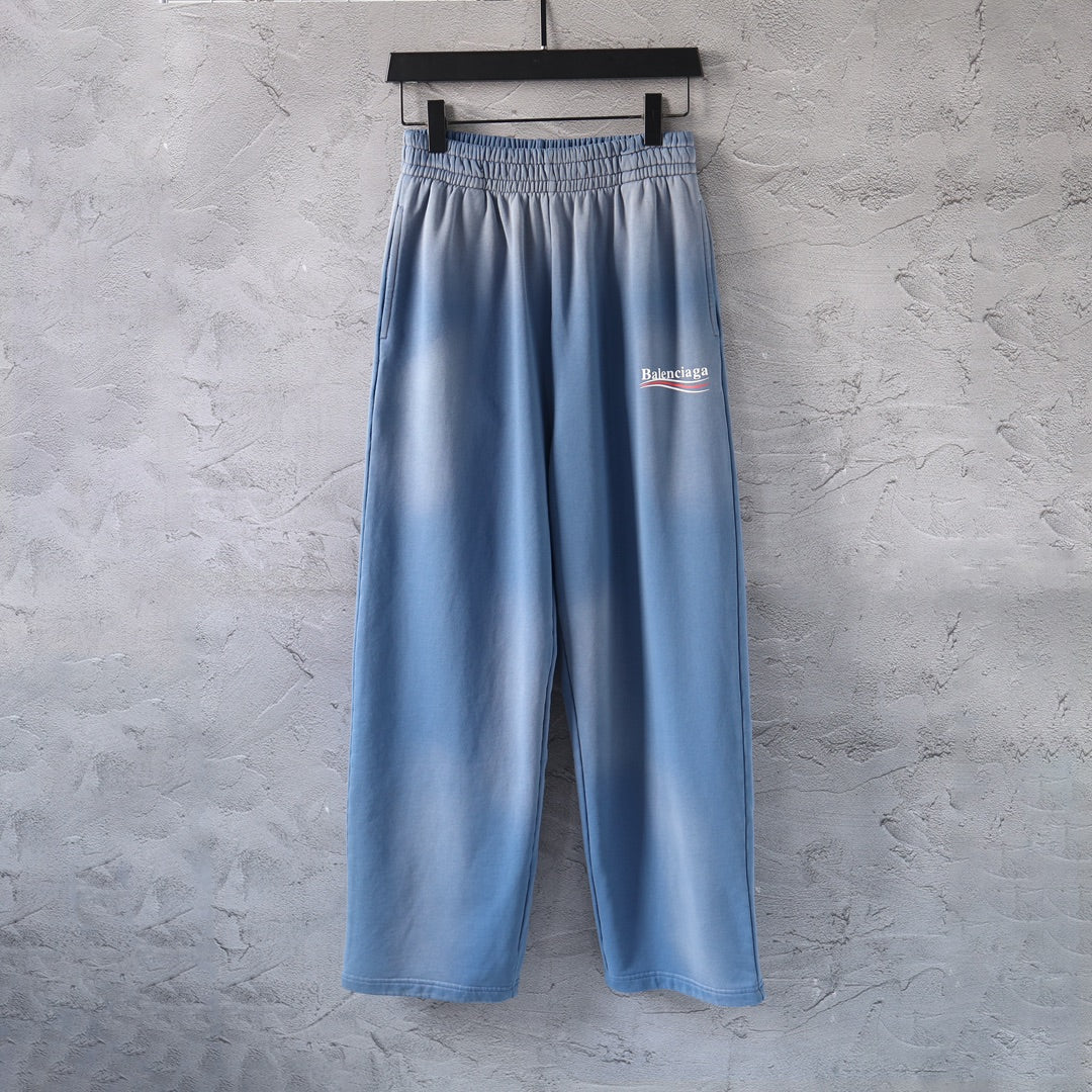 Light blue wide-leg pants with elastic waistband and small Balenciaga logo patch