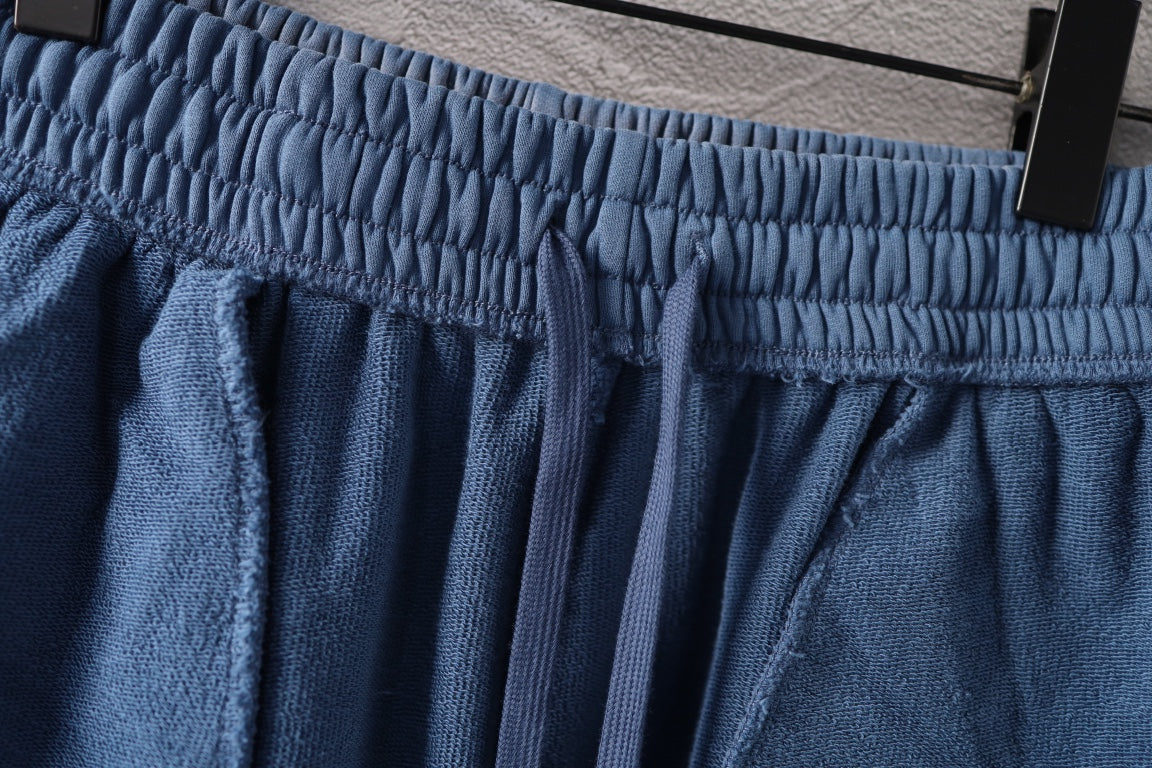 Blue elastic waistband pants with pleats and drawstring ties