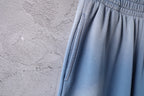 Light blue pants with side seam stitching and elastic waistband