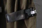 Olive green pants with Balenciaga care label on waistband