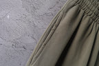 Olive green pants with stitched side seam and ribbed cuff detail