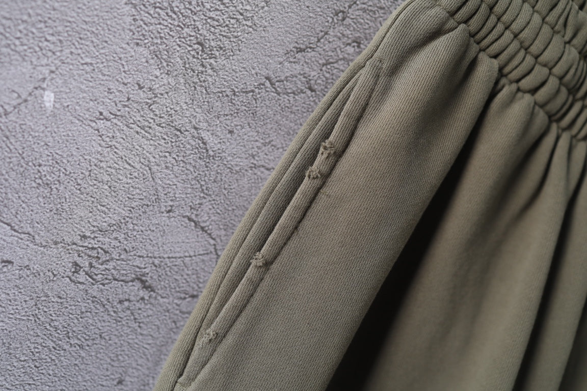 Olive green pants with stitched side seam and ribbed cuff detail