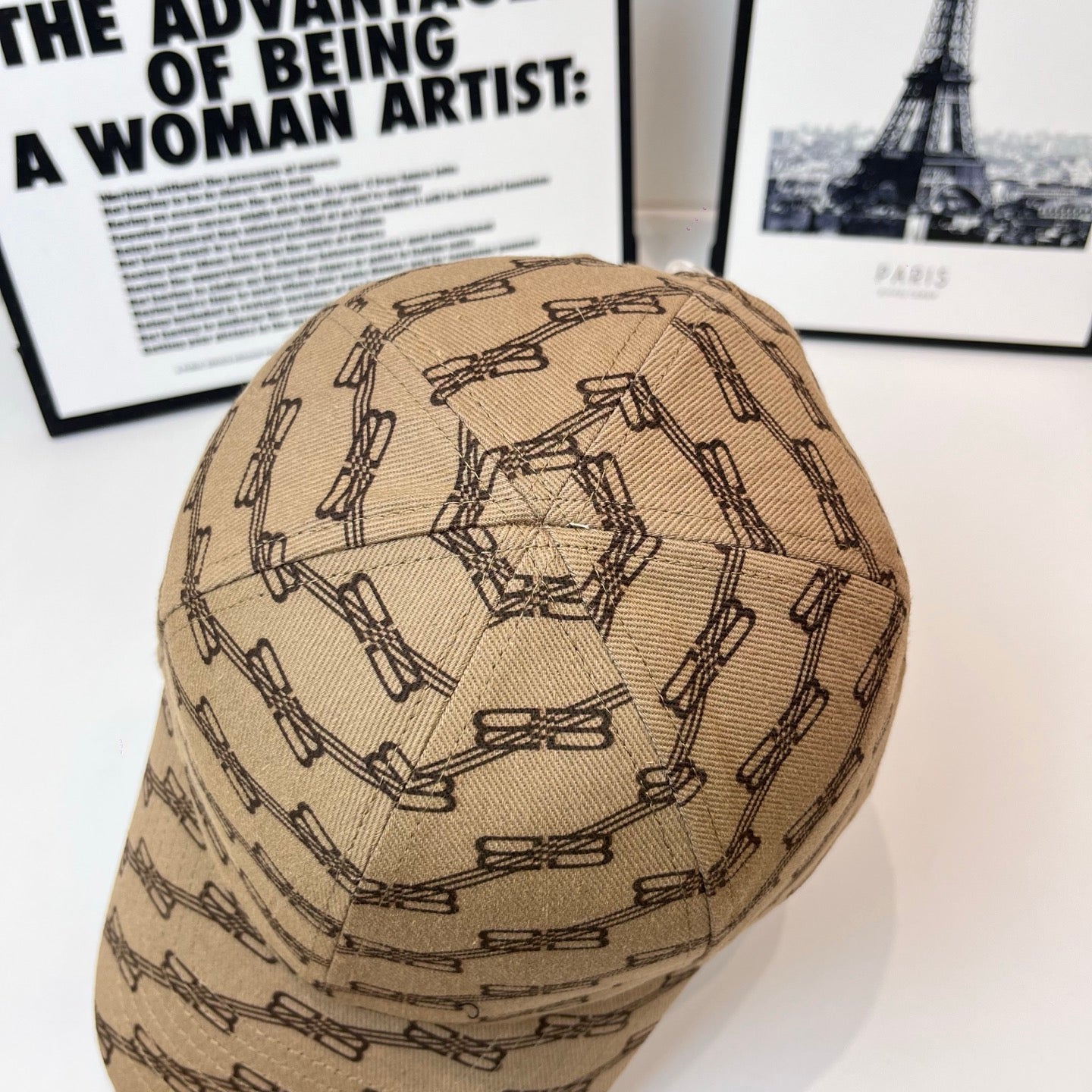 Tan baseball cap with dark chain-link pattern, top view of domed crown