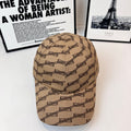 Beige baseball cap with dark chain-link pattern, curved brim and stitched crown