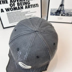 Burberry cap in dark gray back view with curved seams and eyelets