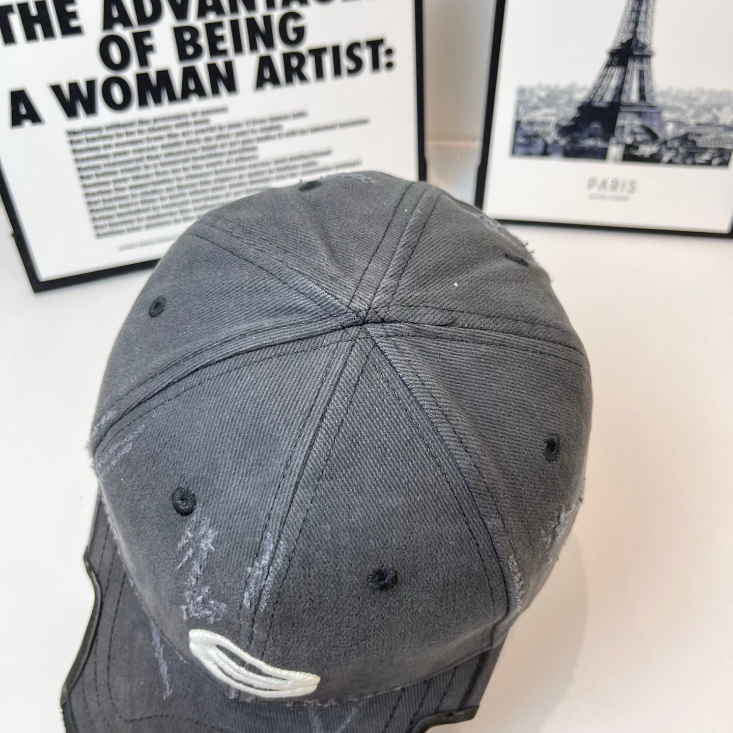 Burberry cap in dark gray back view with curved seams and eyelets