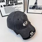 Burberry cap in dark gray with white oval emblem and curved brim