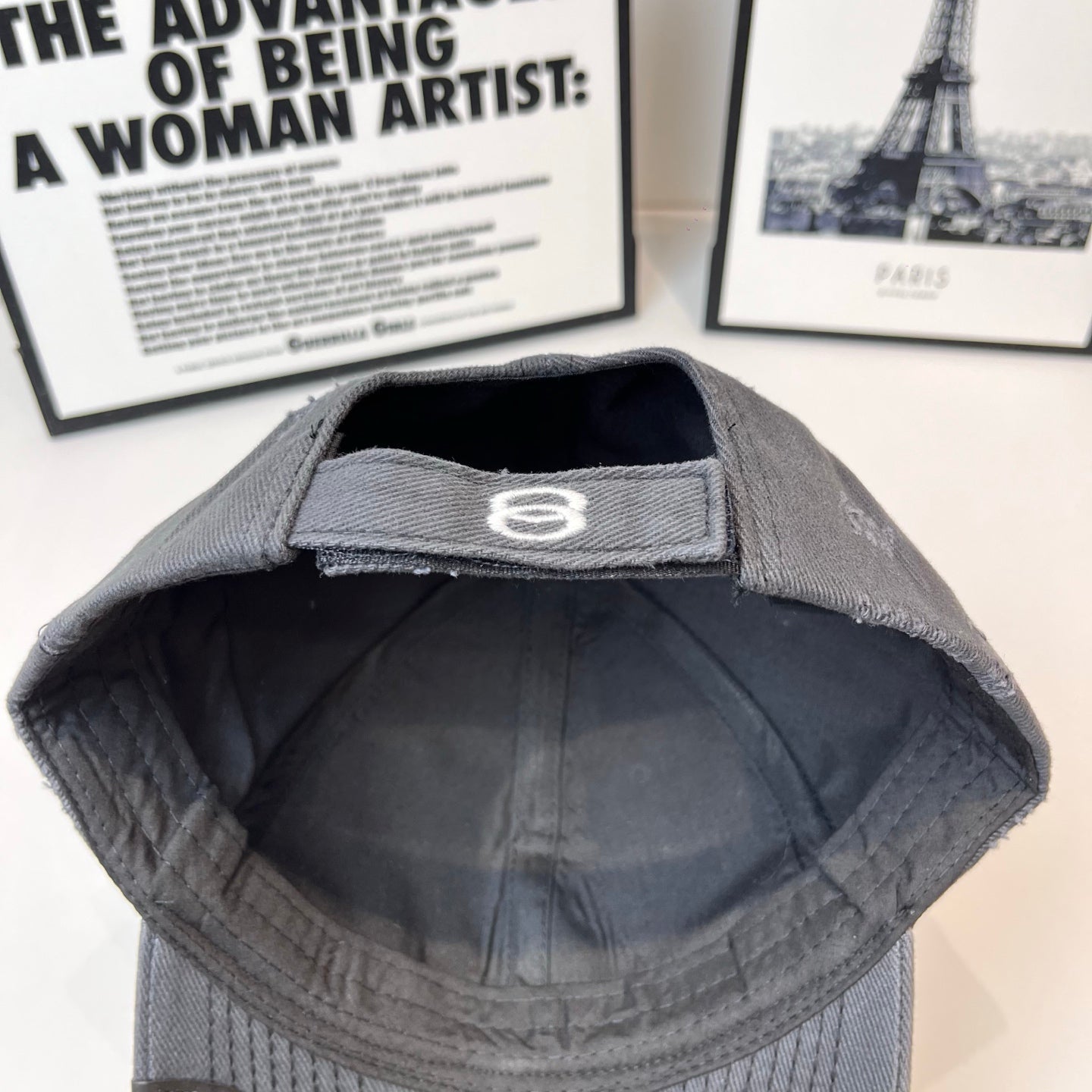 Balenciaga cap lining in dark gray with white 8 logo on inner band