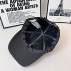 Dior black cap interior showing stitched panels and Dior Homme logo labels.