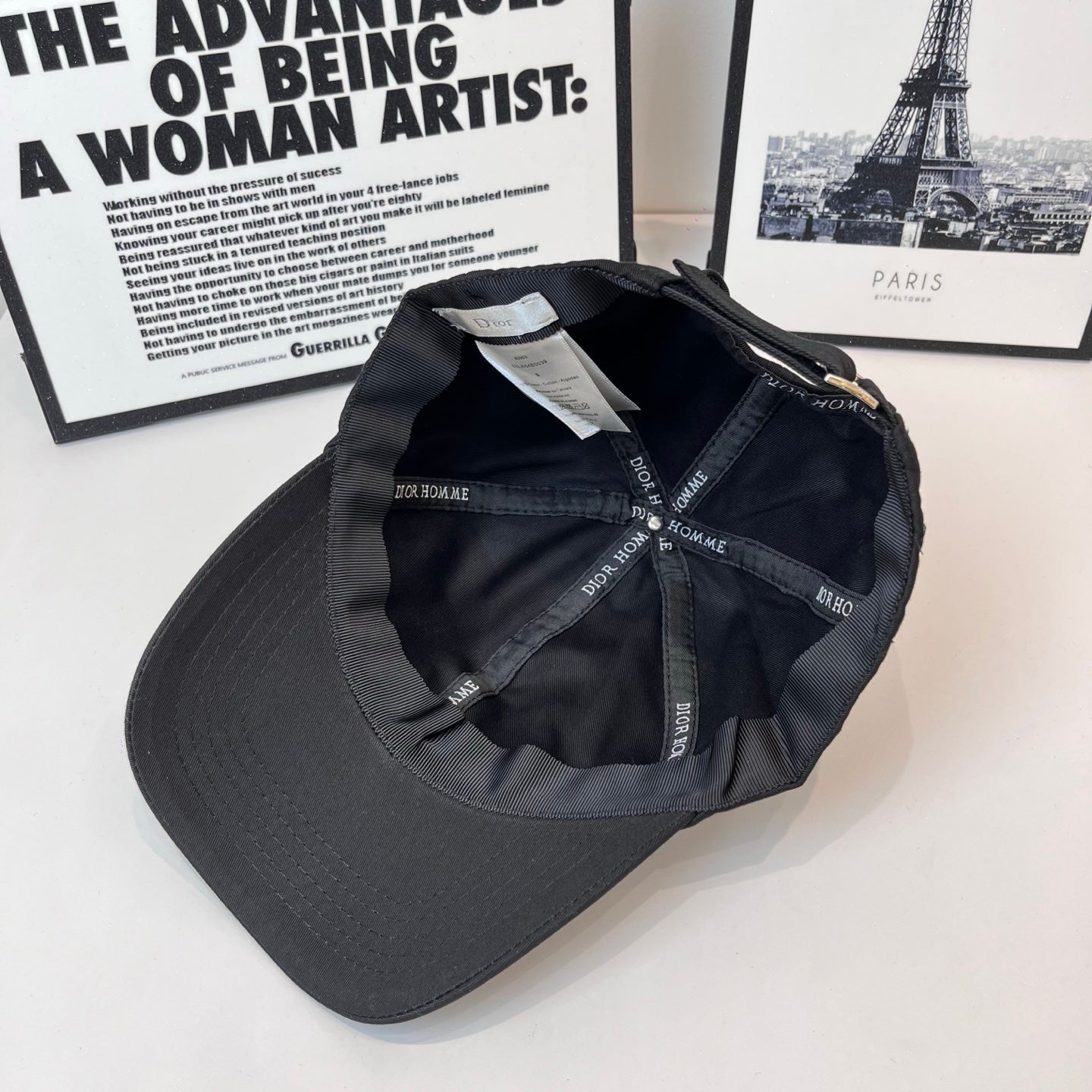 Dior black cap interior showing stitched panels and Dior Homme logo labels.