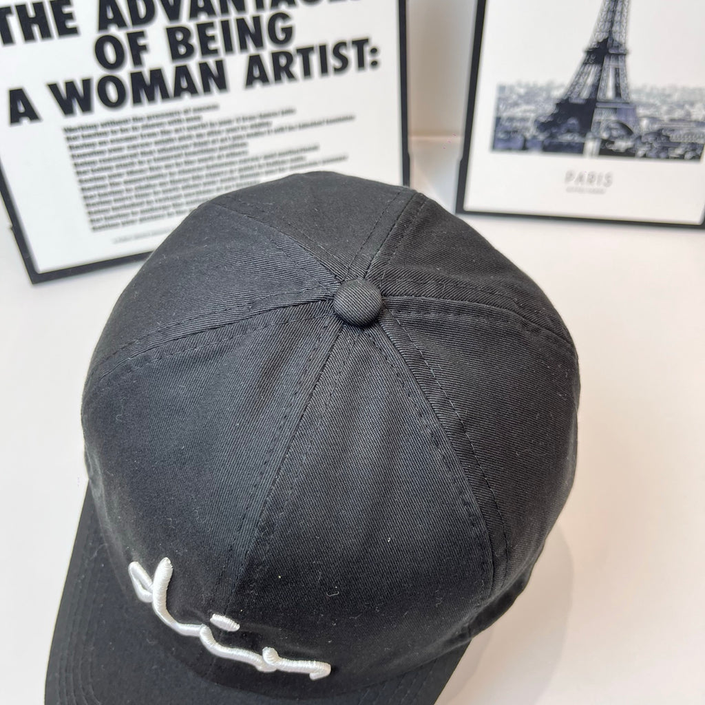 Dior black cap back view with small round button on the crown.