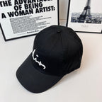 Dior black cap with white cursive logo on the side panel.