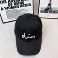 Dior cap in black with a white cursive logo on the front panel.