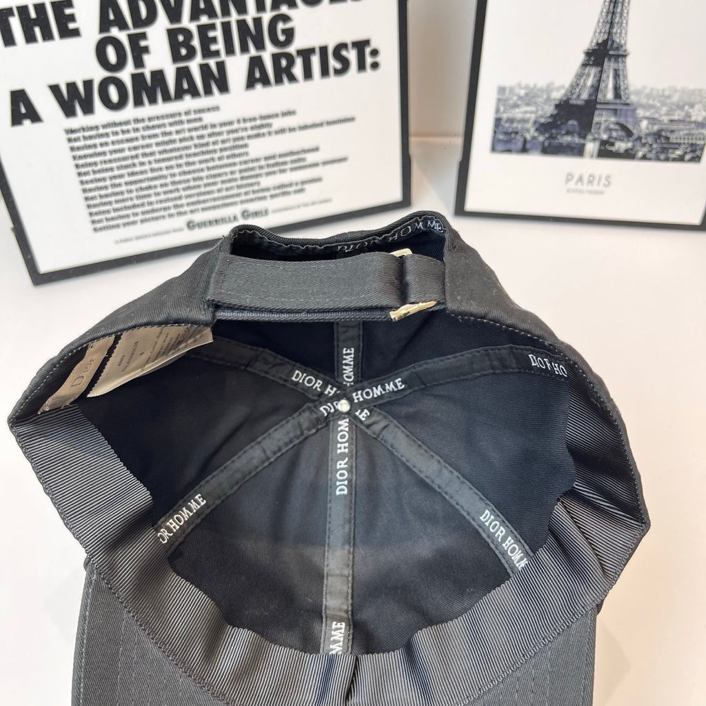 Dior cap interior with stitched panels and repeating Dior Homme logo trim.