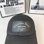 Dark gray baseball cap back view with Christian Dior Atelier logo patch.