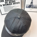 Dark gray baseball cap top button and side Dior patch label.