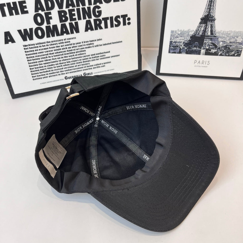 Dark cap interior showing Dior Homme printed lining and adjustable strap.