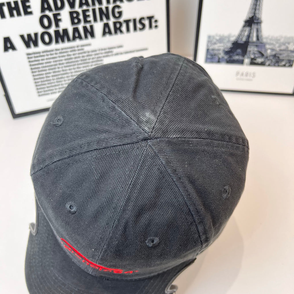 Black denim baseball cap back view with stitched panels and eyelets