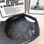 Black denim baseball cap interior with quilted lining and side tag label