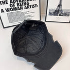 Black denim baseball cap interior view with quilted lining and strap area
