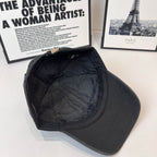 Balenciaga cap interior side view in dark fabric showing curved stitching on crown