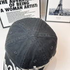 Balenciaga cap back view in dark fabric with stitched panel seams and ventilation eyelets