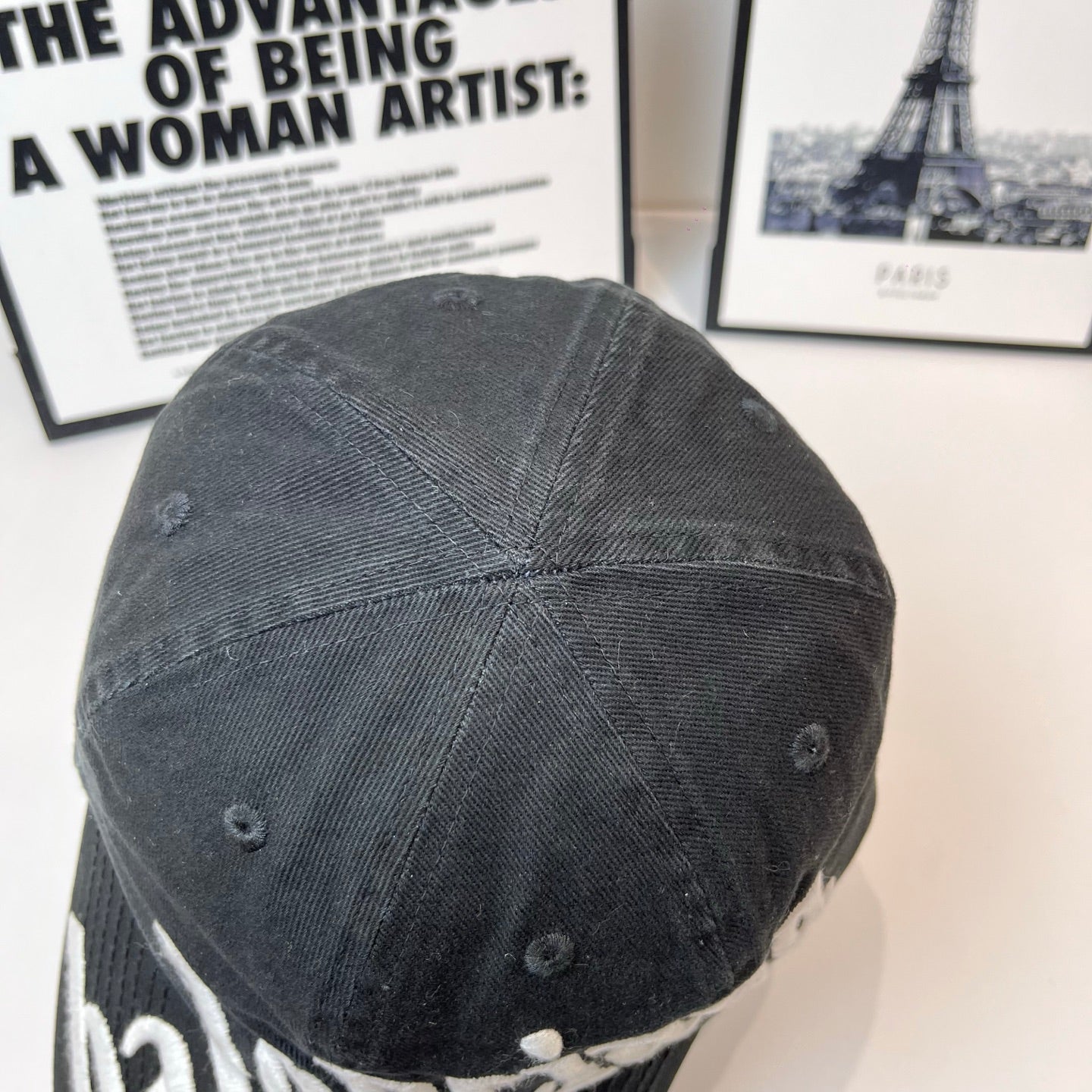Balenciaga cap back view in dark fabric with stitched panel seams and ventilation eyelets