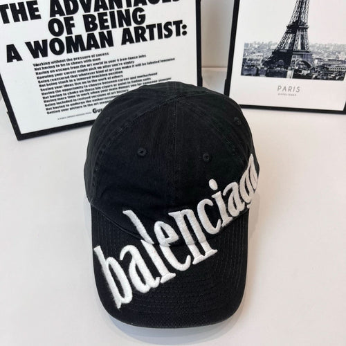 Balenciaga cap in dark fabric with white embroidered “balenciaga” logo on the front