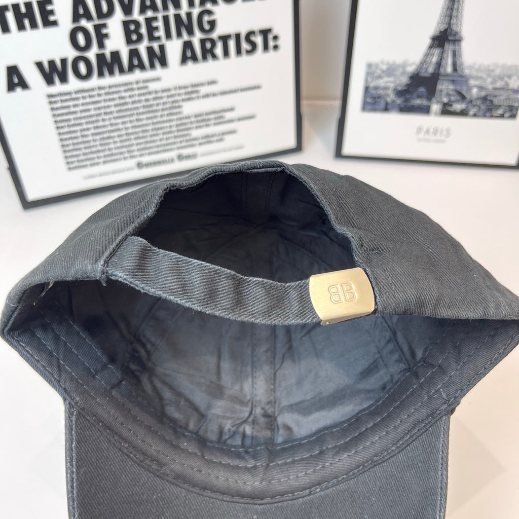 Dark baseball cap interior with stitched lining and adjustable strap with metal buckle.