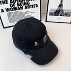 Navy baseball cap with embroidered front logo patch and curved brim