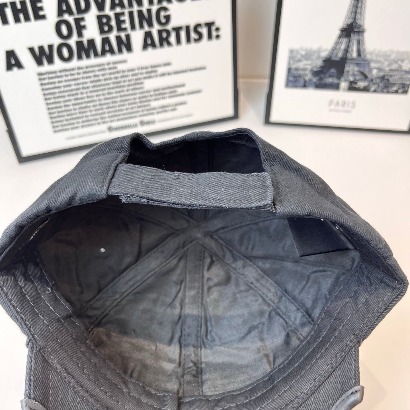 Navy baseball cap interior view showing quilted lining and curved stitched panels
