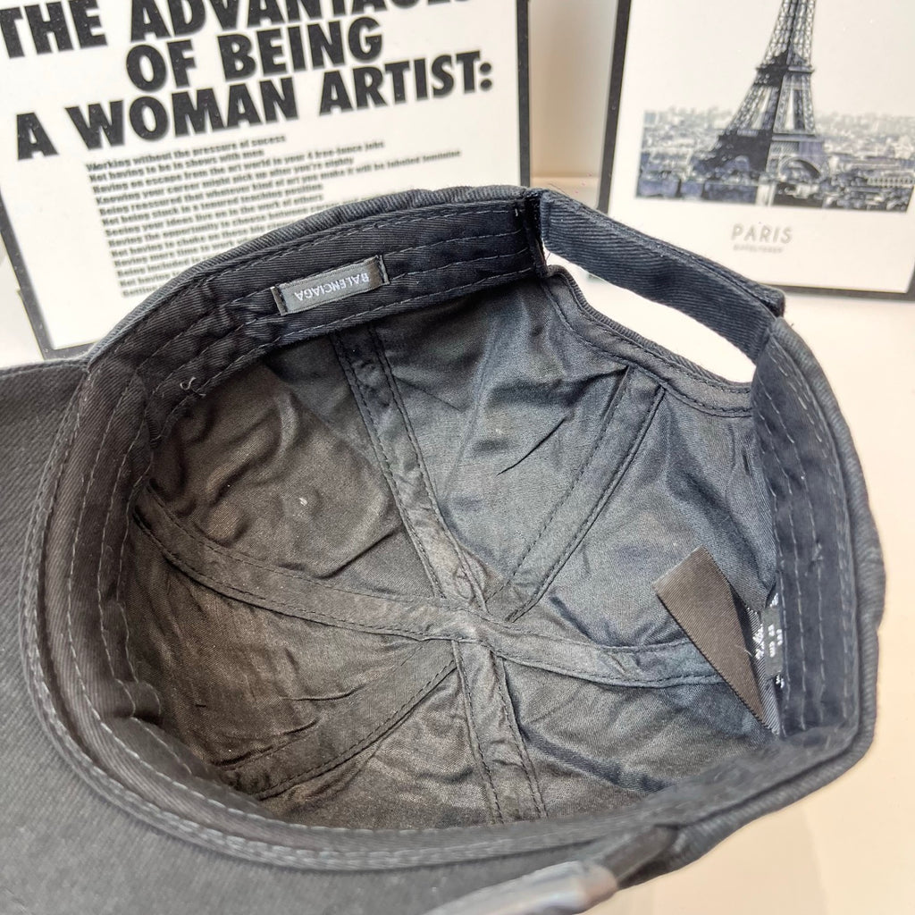 Navy baseball cap inner lining with sewn seams and brand label at back