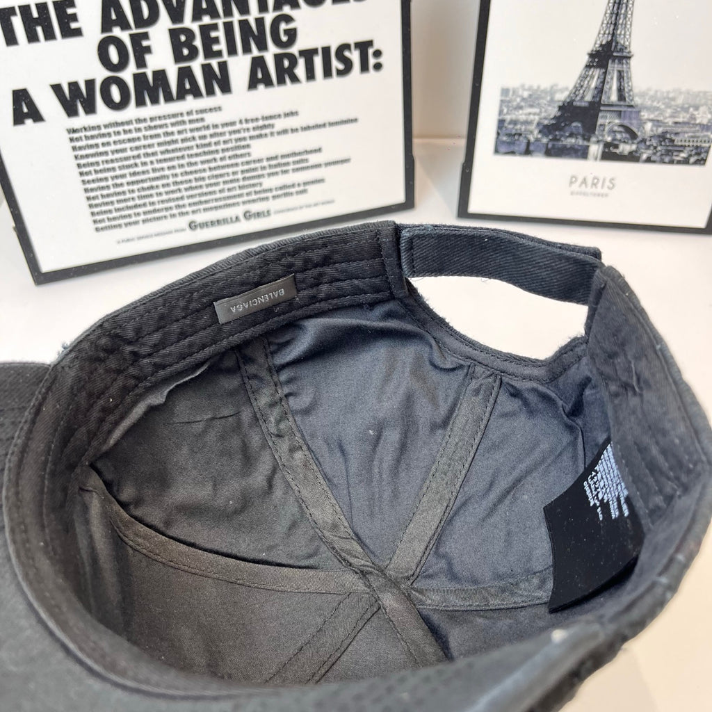Baseball cap interior with fabric lining and adjustable strap near back