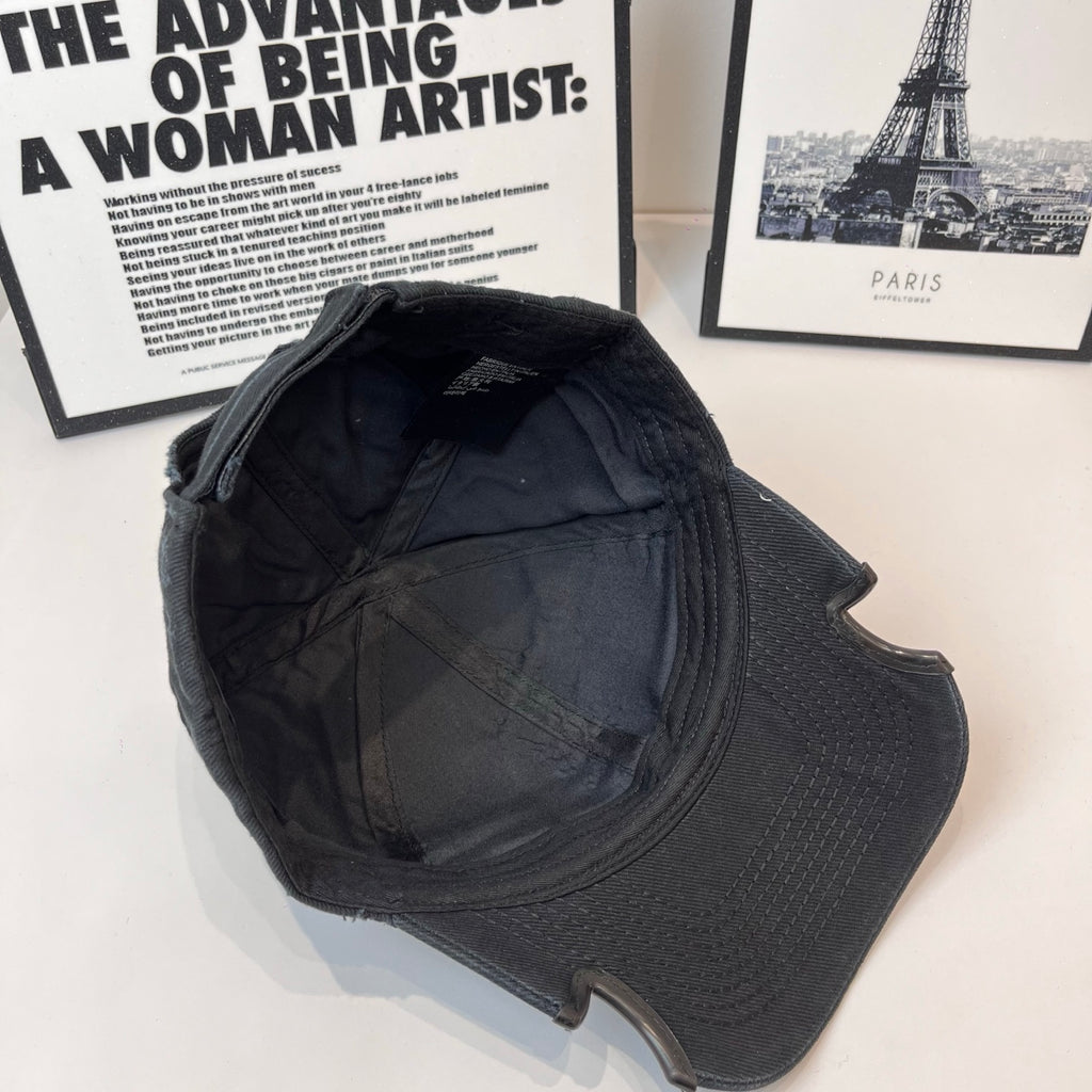 Black Balenciaga cap interior side view with quilted lining and stitched seams