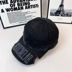 Black Balenciaga cap with curved brim and side BALENCIAGA embroidered text