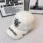 Burberry cap, white twill with cartoon front embroidery and BALENCIAGA logo on brim