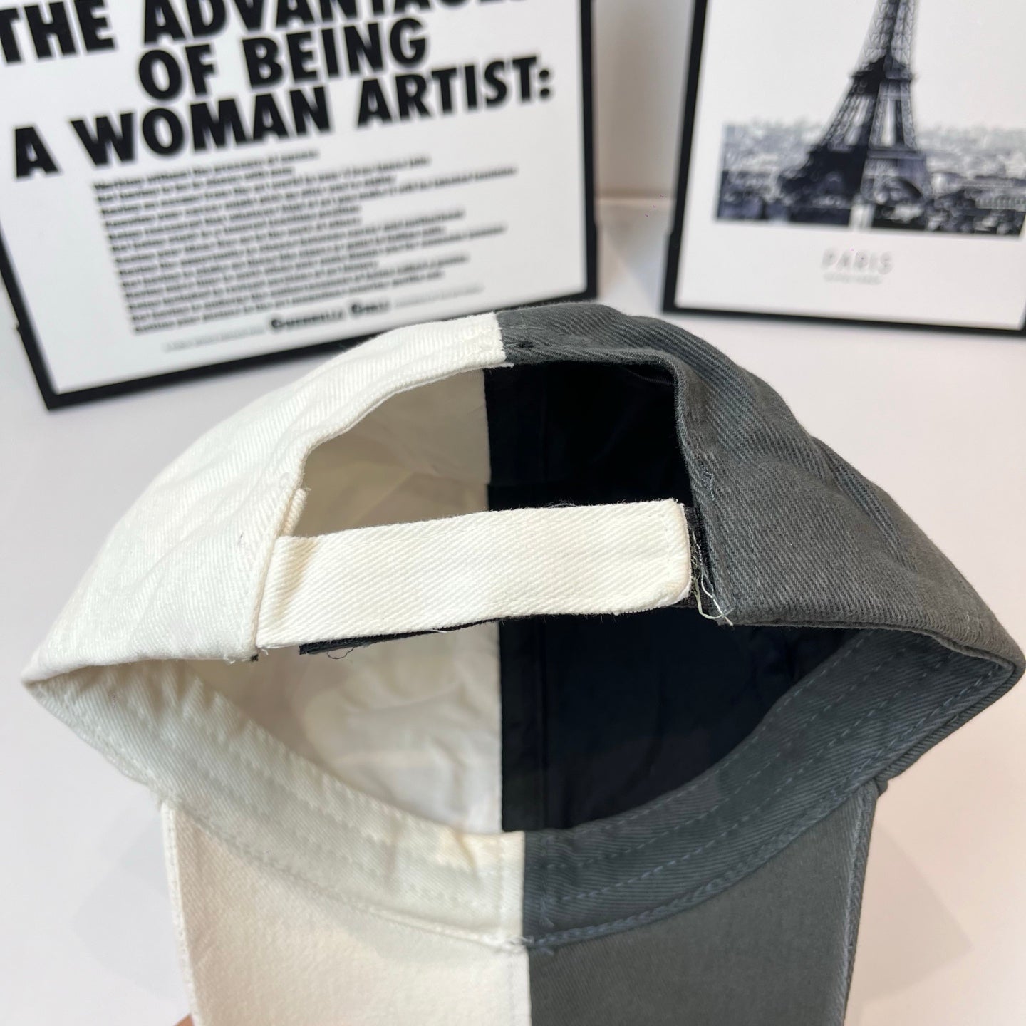 Two-tone baseball cap interior view, black lining and dark brim trim.
